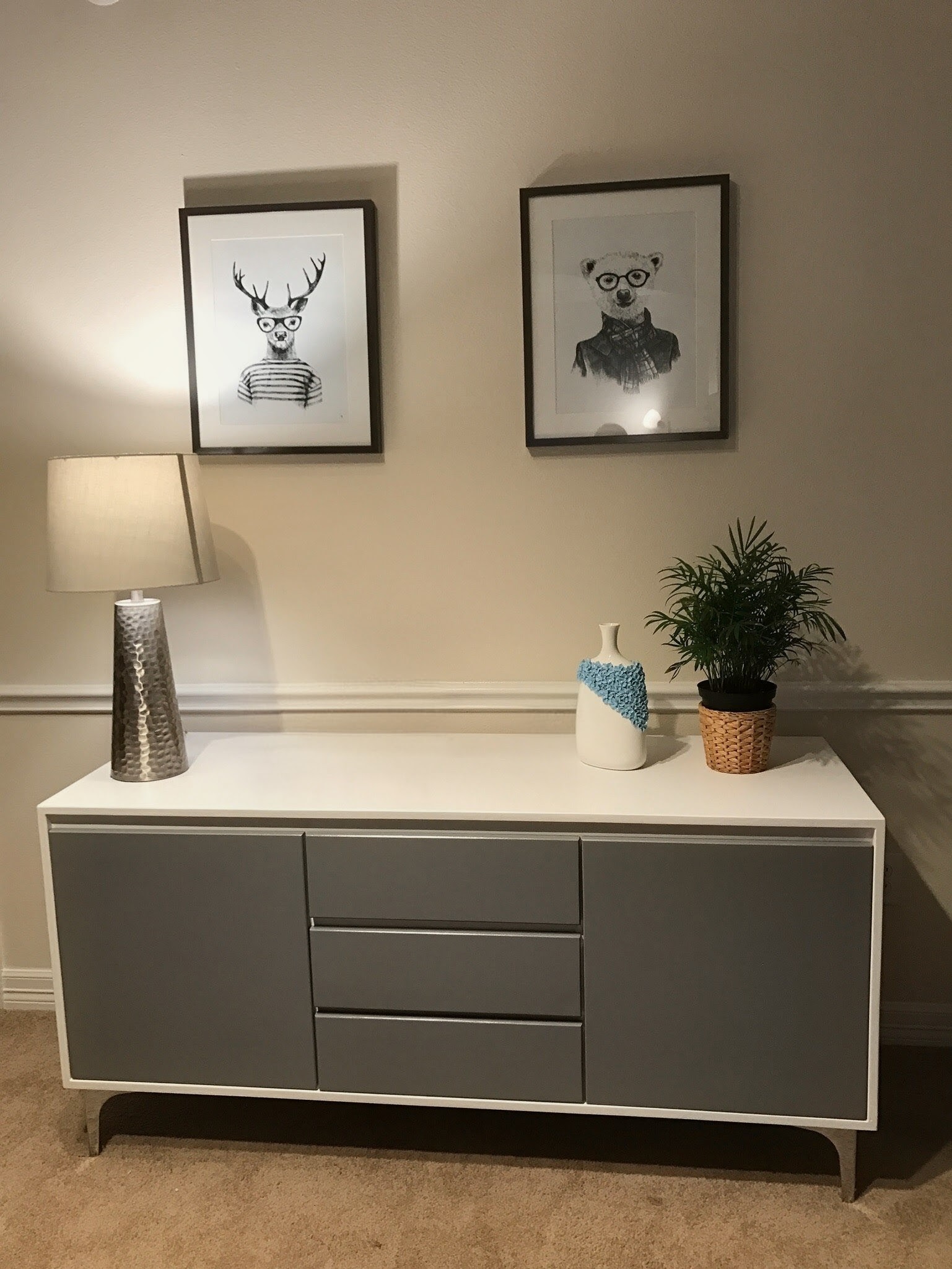 Two-tone painted sideboard styled in a living room